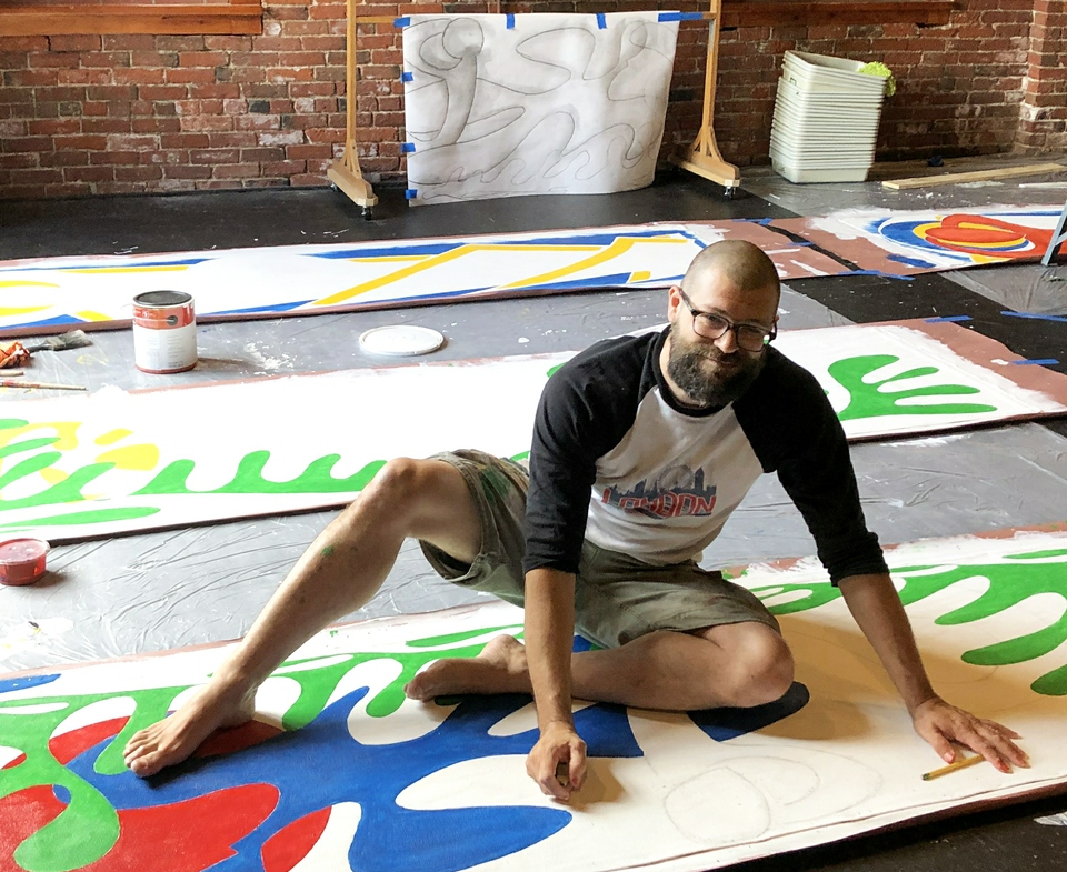 Artist Jeremy Barnett working on MLT Building facade art project